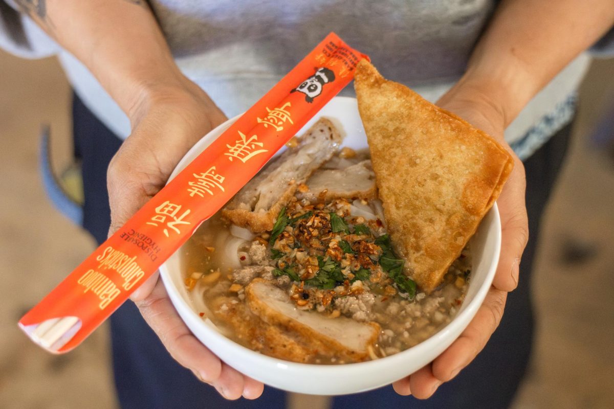 Jam Sanitchat, owner and founder of Thai Fresh, holds a dish on Sunday Apr. 19, 2026.