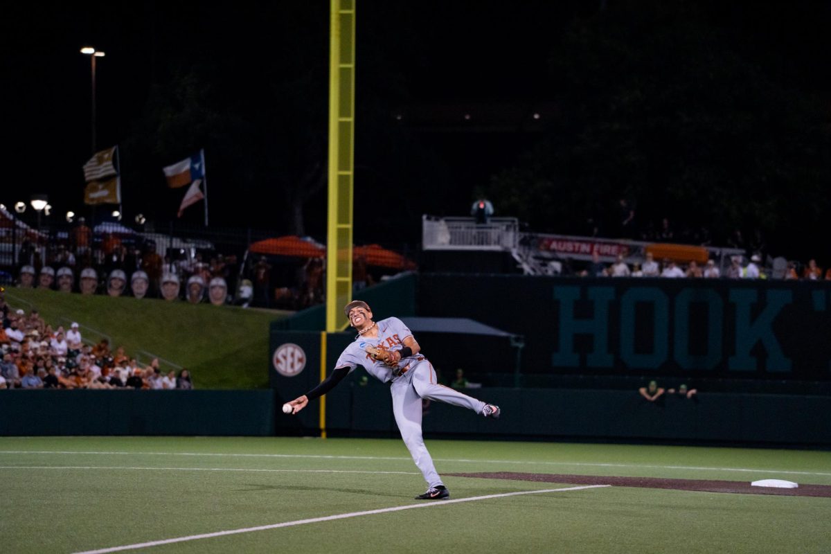 Sophomore shortstop Adrian Rodriguez attempts to throw out a runner at first during Game 2 of the Austin Super Regional against Oregon on Sunday, June 7 at UFCU Disch-Falk Field.
