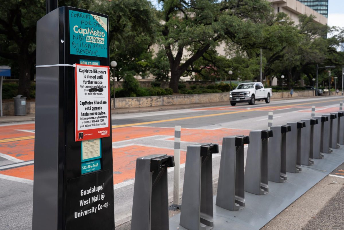 An empty CapMetro Bikeshare dock on Guadalupe Street is pictured Wednesday, June 17, with a sign stating, "CapMetro Bikeshare is closed until further notice." This closure follows a May 23 fire at CapMetro’s Bikeshare maintenance facility that damaged bike batteries and chargers, according to the CapMetro website.