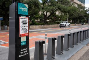 An empty CapMetro Bikeshare dock on Guadalupe Street is pictured Wednesday, June 17, with a sign stating, "CapMetro Bikeshare is closed until further notice." This closure follows a May 23 fire at CapMetro’s Bikeshare maintenance facility that damaged bike batteries and chargers, according to the CapMetro website.