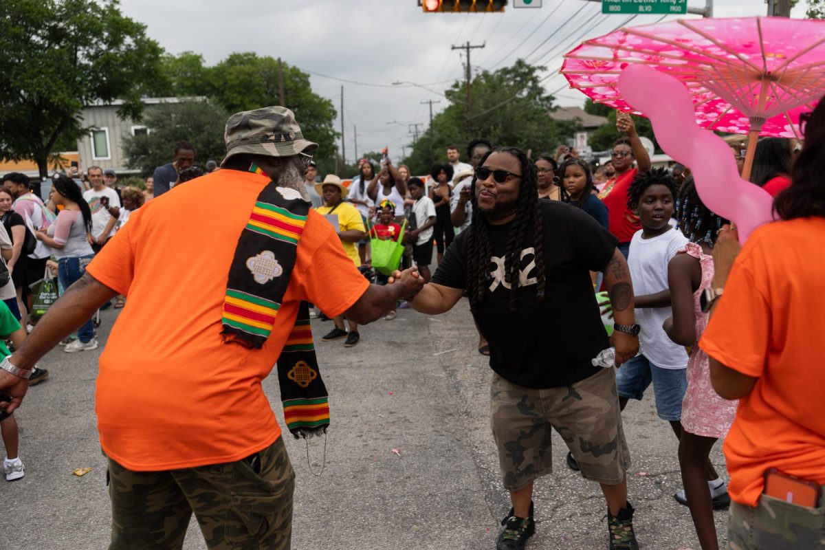 Parade-goers connect over their love for their community at the Central Texas Juneteenth Parade in East Austin on Friday, June 19.