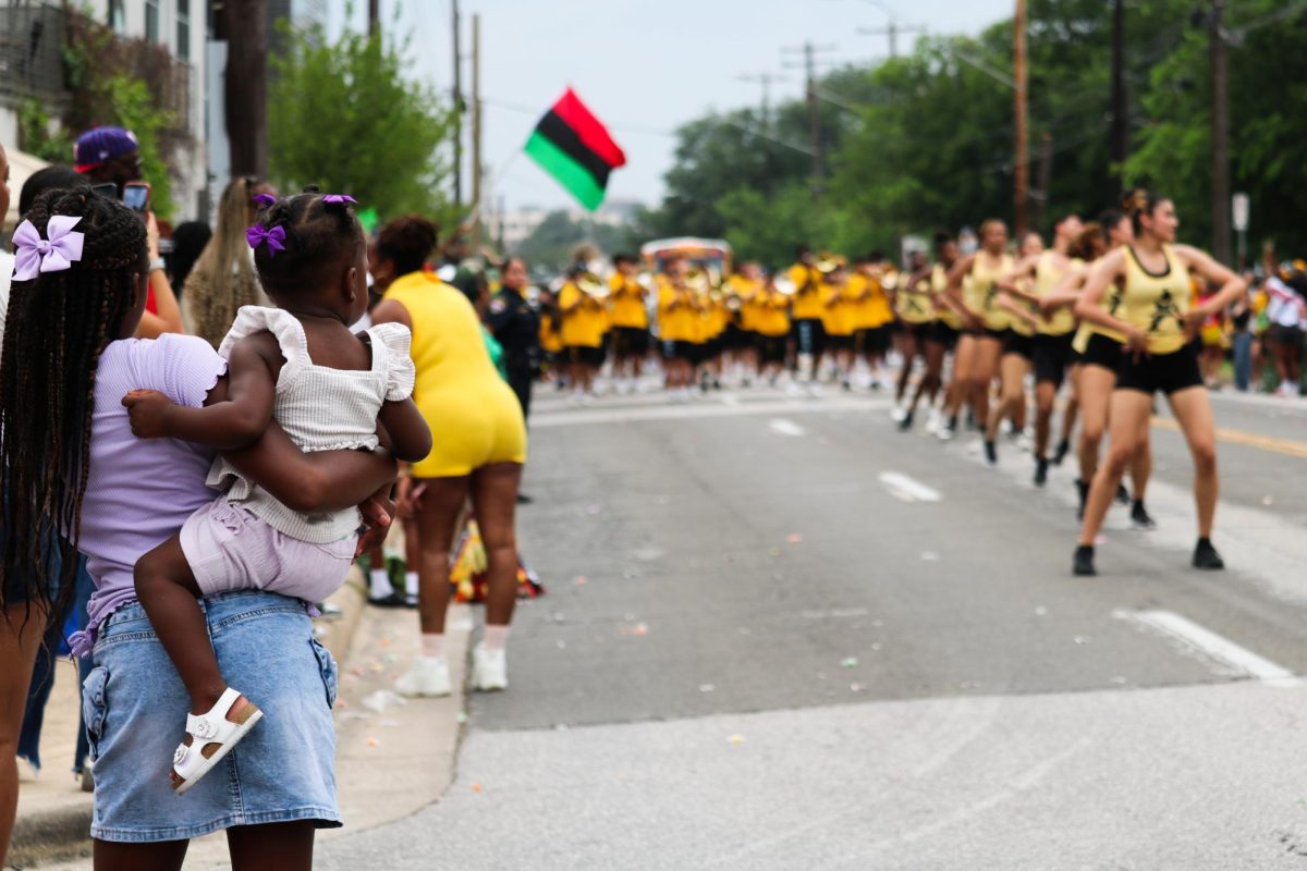 A crowd watches the Austin All-Star Band dancers during the Central Texas Juneteenth Parade on Friday, June 19.
