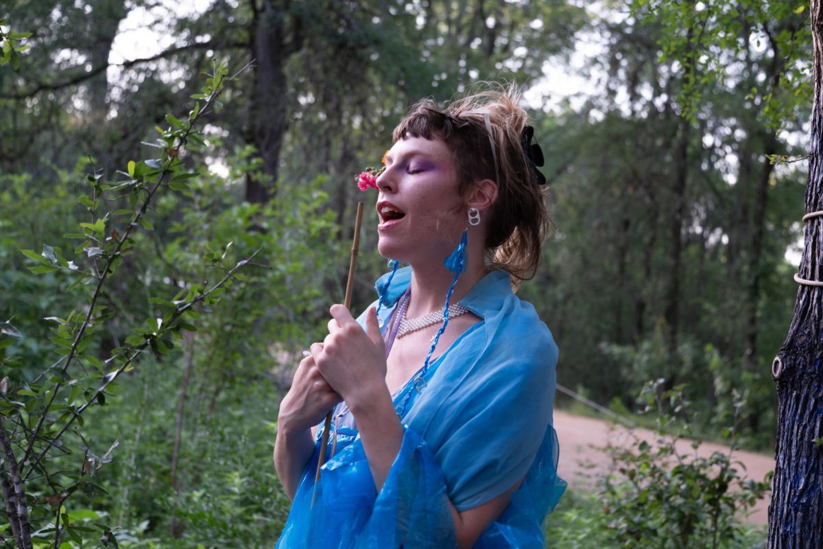 Love sings in the crowd during the "An Evening for Malin" memorial in Pease Park on Wednesday, June 24,. 