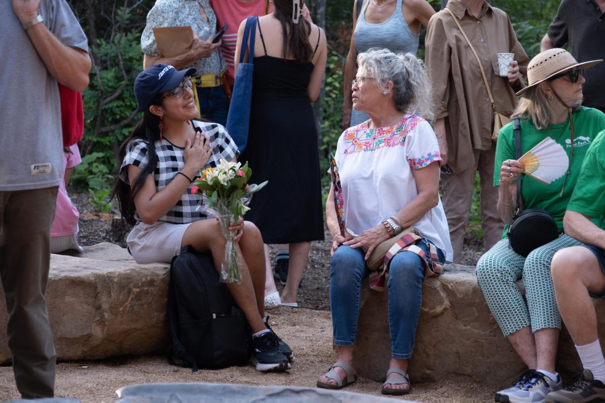 Luisa Apolaya and Laura Martinez converse in the crowd during the "An Evening for Malin" memorial in Pease Park on Wednesday, June 24. 