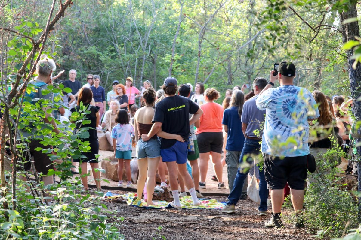 Austinites gather around Malin's Fountain during her memorial service as speakers commemorate the loss of the beloved sculpture in Pease Park on Wednesday, June 24.