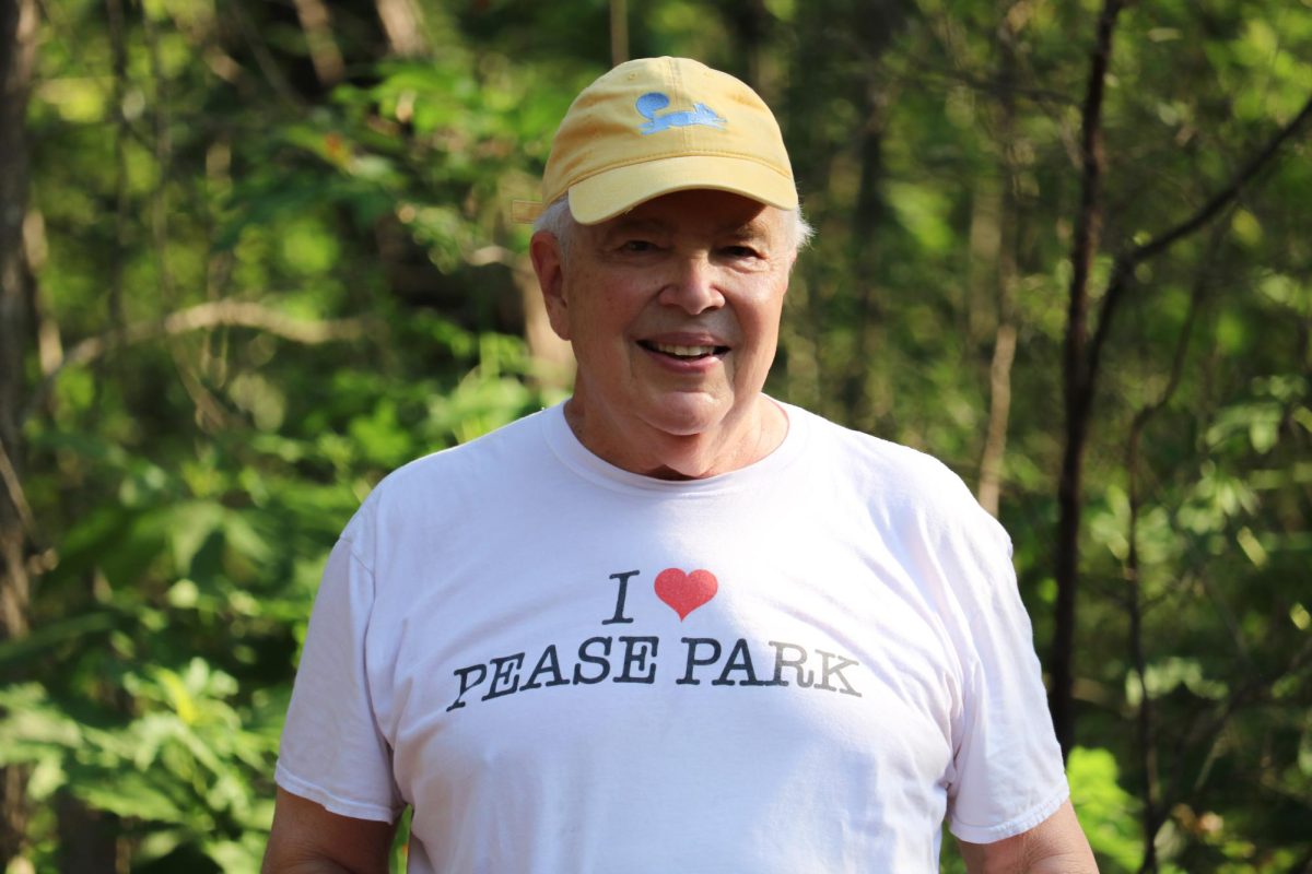 An Austin resident gathers in the crowd surrounding the spot Malin once stood, dressed in "I Heart Pease Park" shirt swag for Malin's Memorial in Pease Park on Wednesday, June 24.