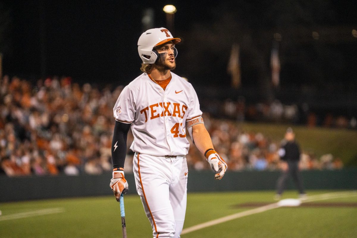 Junior outfielder Aiden Robbins returns to the dugout during an 8-1 home win against Michigan State on Feb. 20.