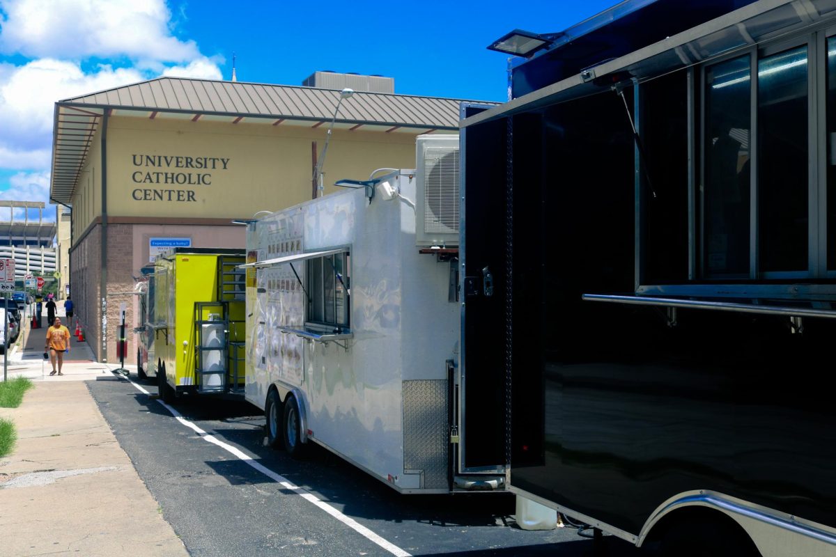 A strip of on-campus food trucks sit parked near W 21st Street on June 17, 2026.