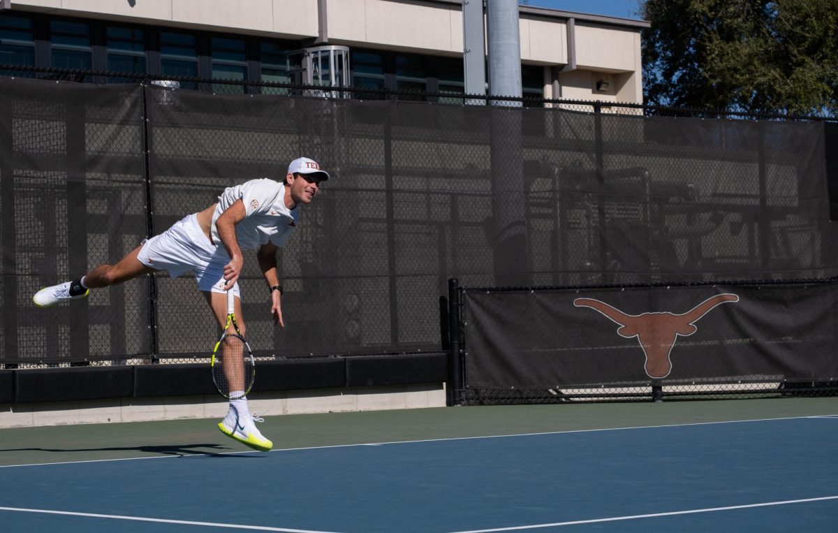 Senior Sebastian Gorzny hits ball during a singles match against Virginia on Jan. 18.