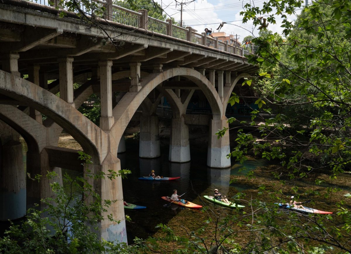 People kayak under Barton Springs Bridge on Wednesday, July 1. Austin City Council recommended the bridge be replaced in Dec. 2023, with construction projected to begin summer 2027.