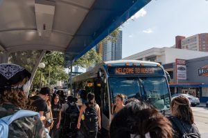 Students crowd around a station waiting to board a CapMetro bus at the Guadalupe and West Mall UT stop on Aug. 28, 2025.