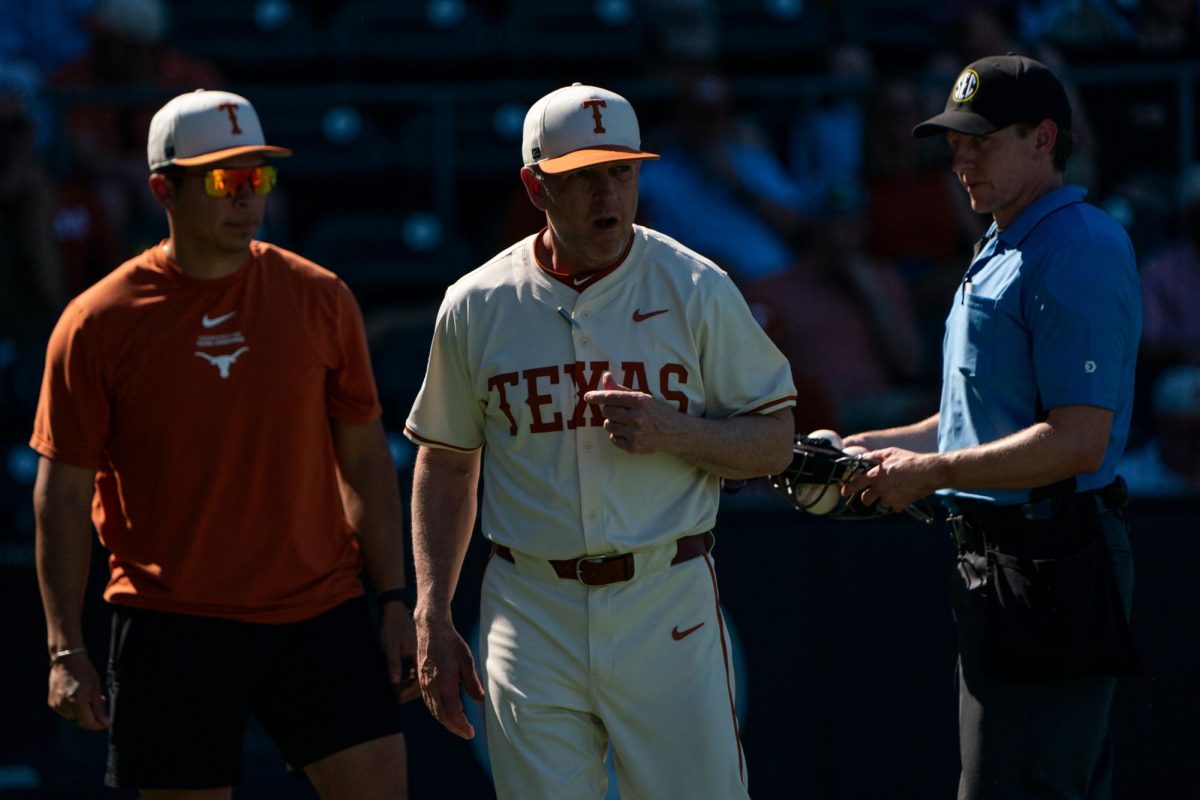 Head coach Jim Schlossnagle talks to a referee during Texas’ game against Ole Miss in Austin, Texas on Sunday, March 15, 2026 