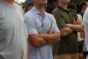 Attendees wear green ribbons at the vigil on July 8, 2025.