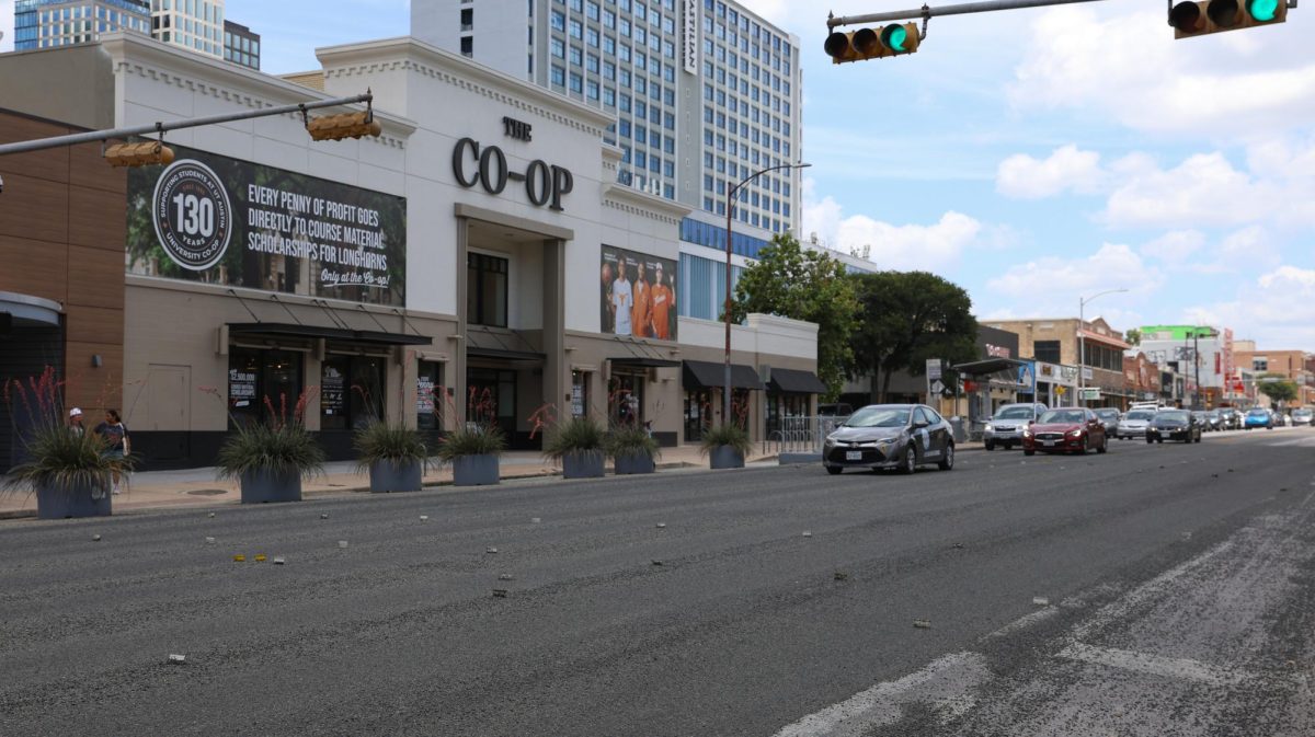 The section of Guadalupe St. formerly adorned with a 'TEXAS' street mural is covered in gravel after a late night removal July 2.